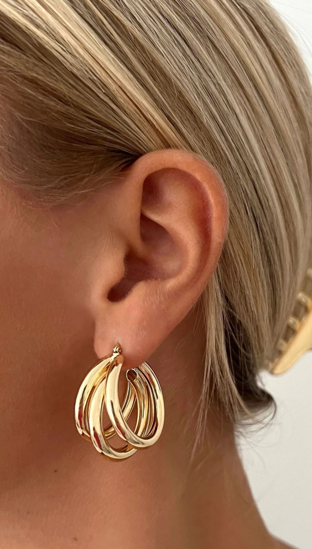 Gold triple hoop earrings.