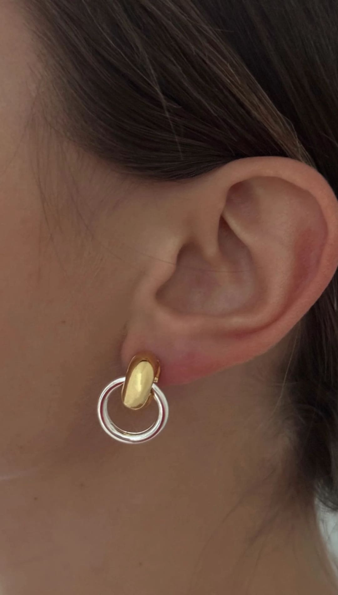 Two-tone circular earring.