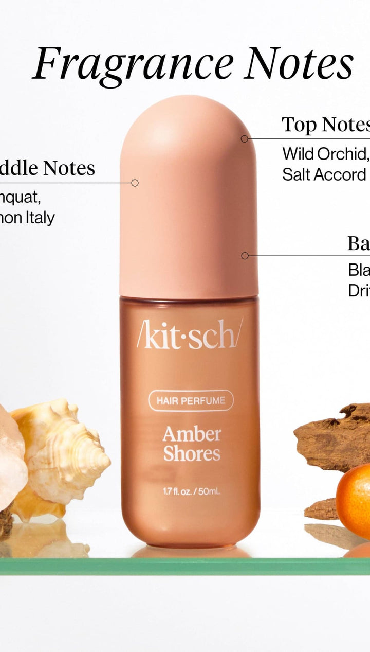 Amber shores perfume bottle with peach-colored cap and gold label, featuring a minimalist design.