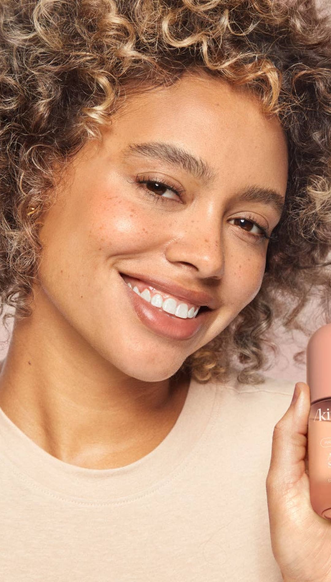 Pink matte nail polish bottle with black cap and text, kiehl’s brand.