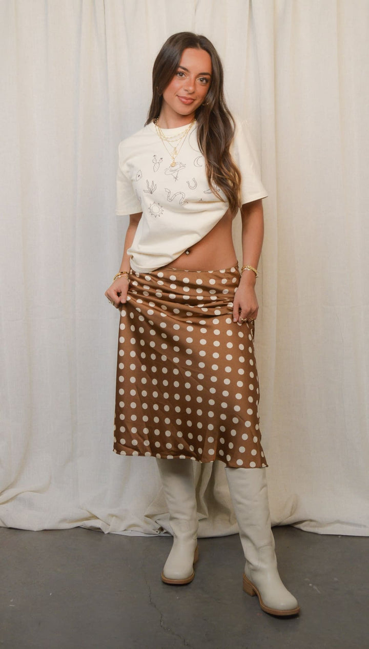 Woman in polka dot skirt and boots.