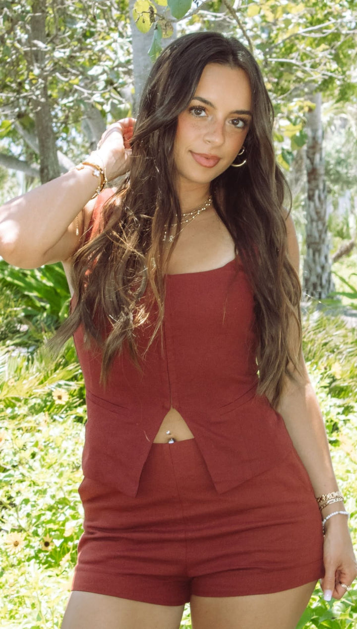 Woman in matching rust-colored shorts and top.