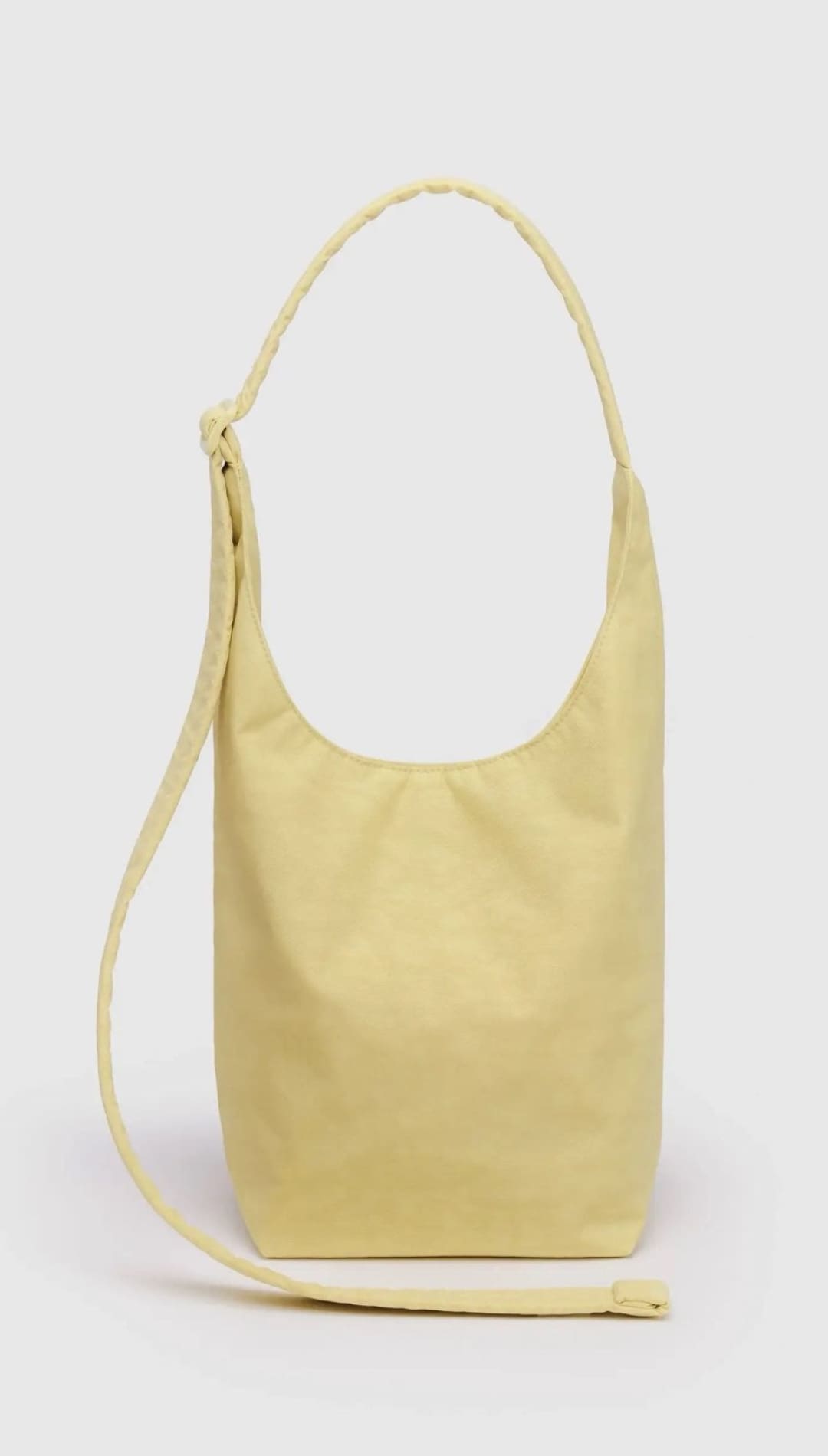Yellow shoulder bag with braided strap.