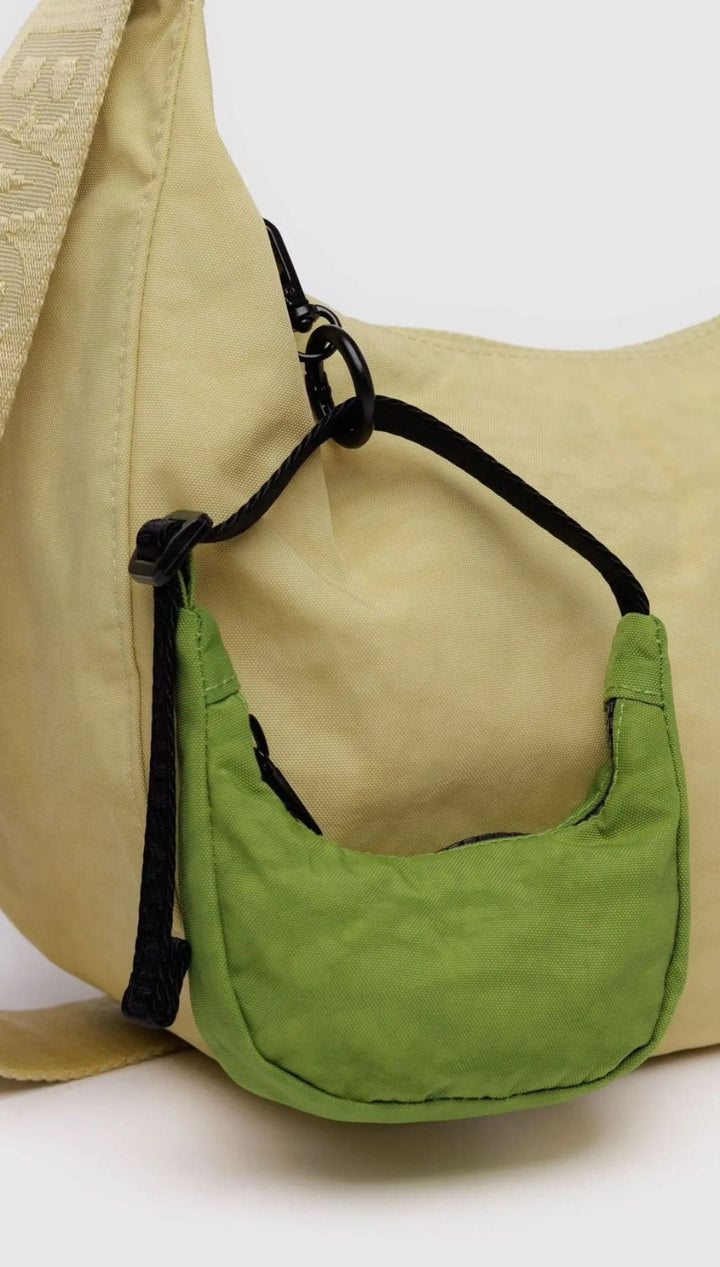 Beige hobo bag with green mini-purse.