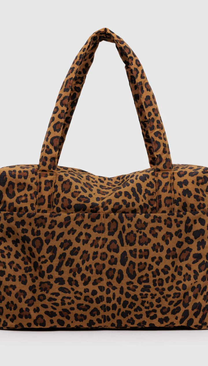 Leopard print tote bag with brown and black spots on a tan background, made of fabric.