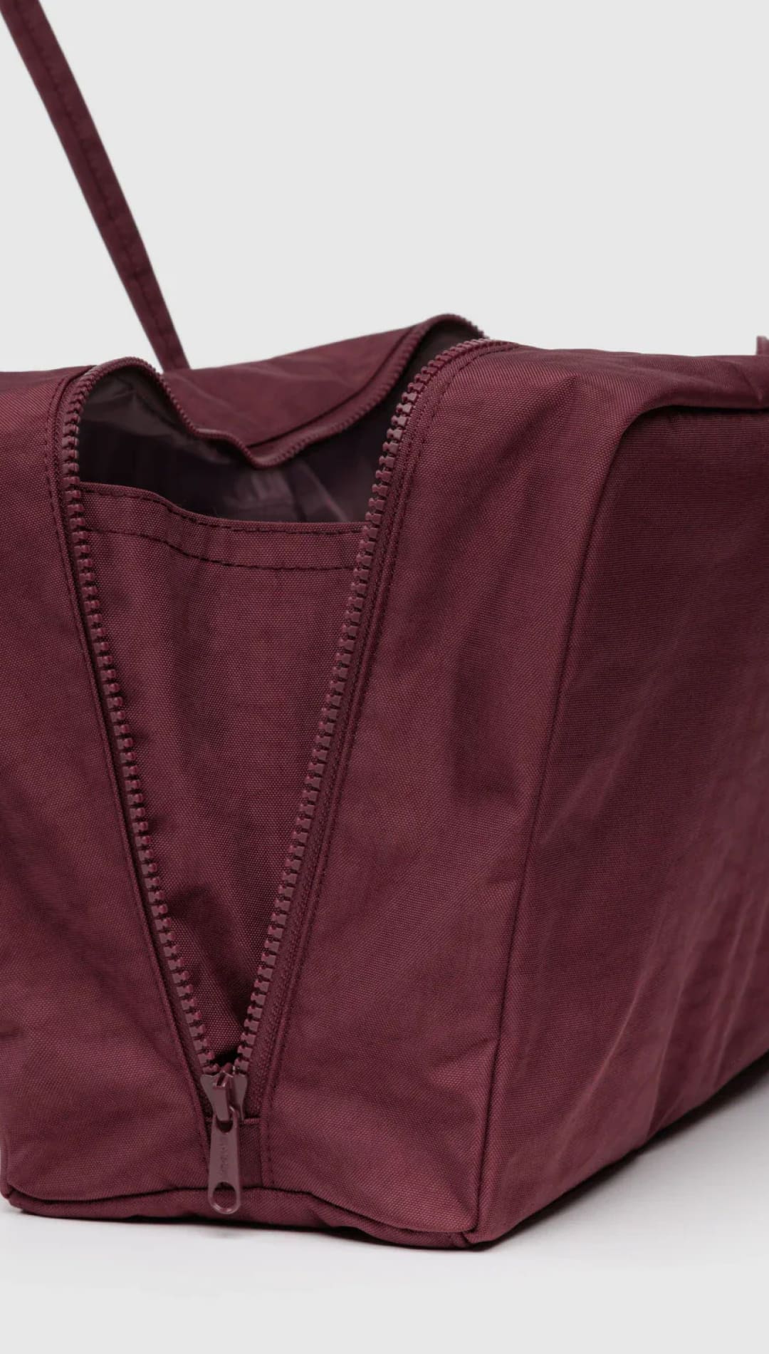 Burgundy tote bag with zipper closure and adjustable straps.