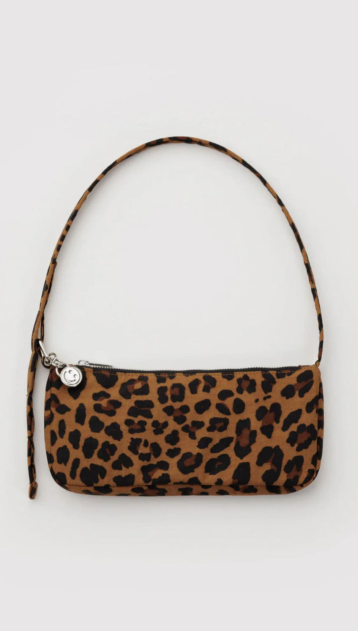 Leopard print handbag with a single shoulder strap and silver button closure.