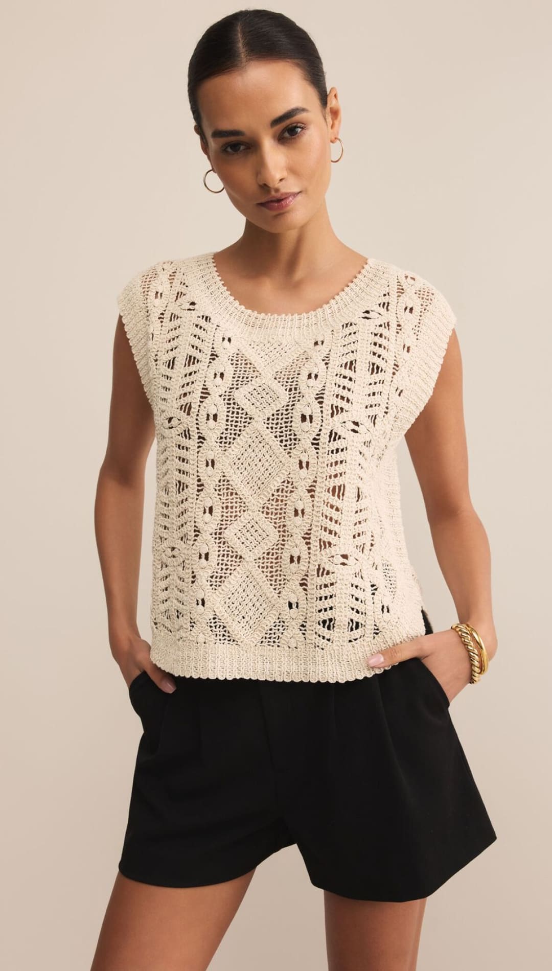 Women’s cream-colored open-knit top with a round neck and short sleeves.
