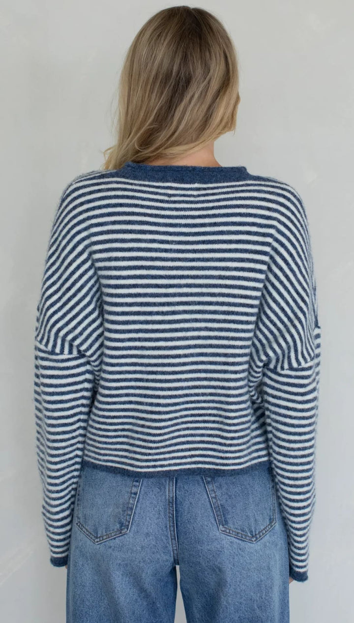 Striped navy and white long-sleeve sweater with a relaxed fit.