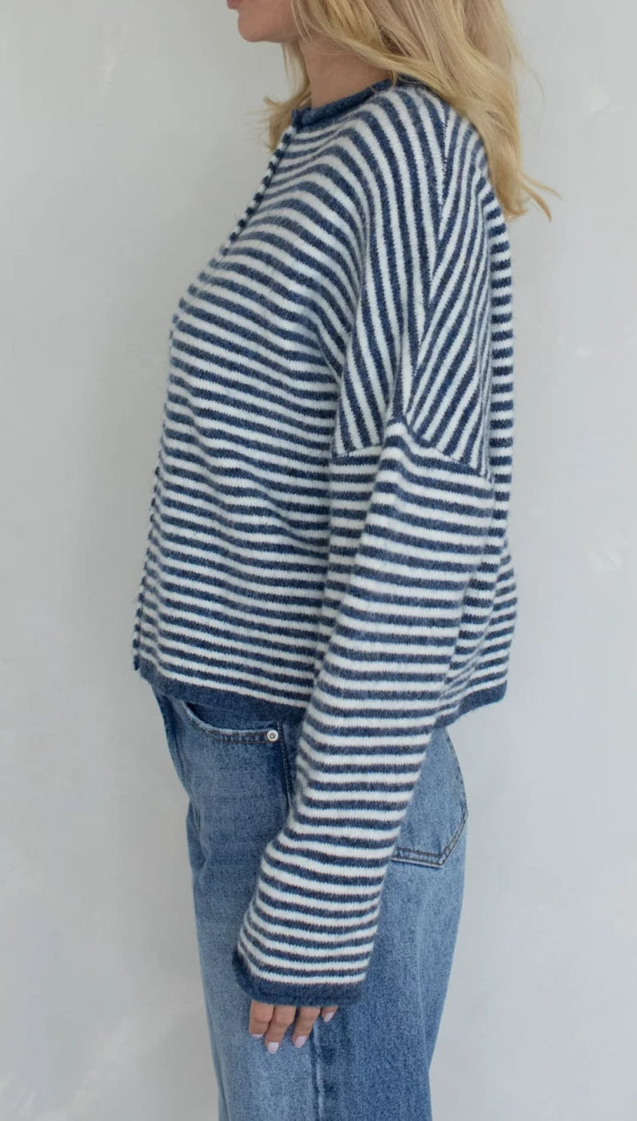 Striped sweater with navy and white stripes, made of soft cotton.