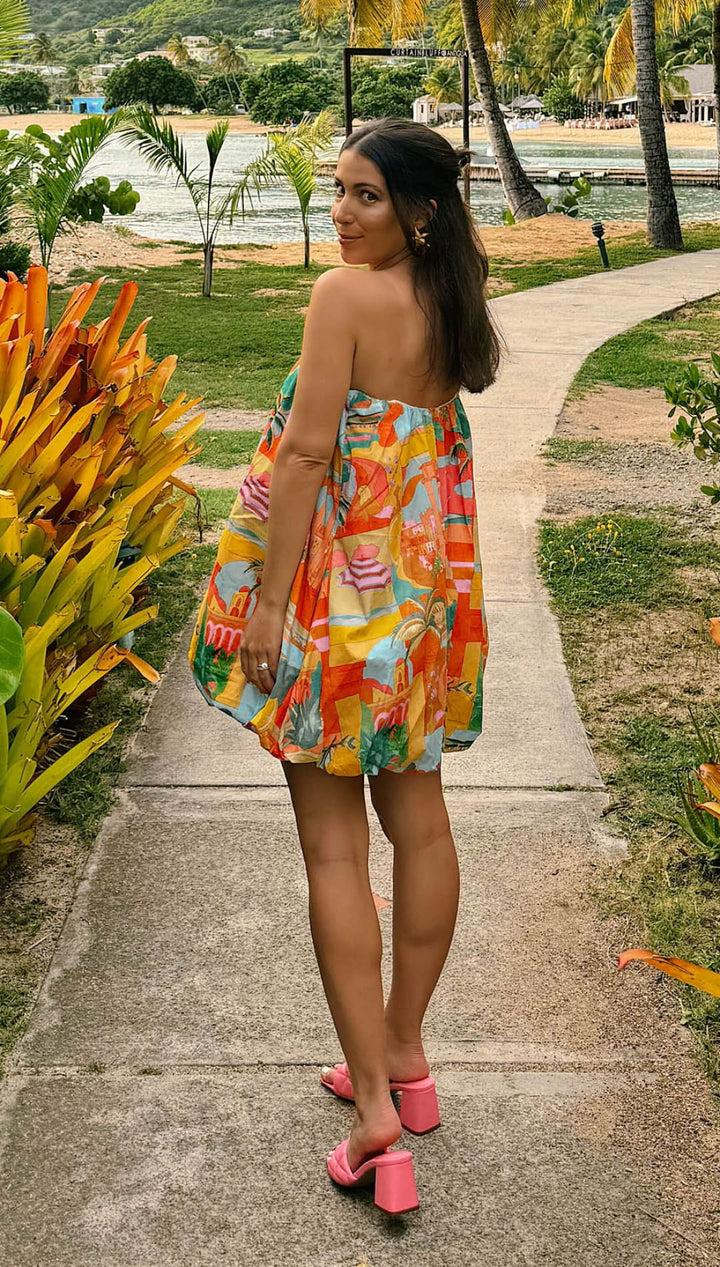 Woman in colorful strapless dress.