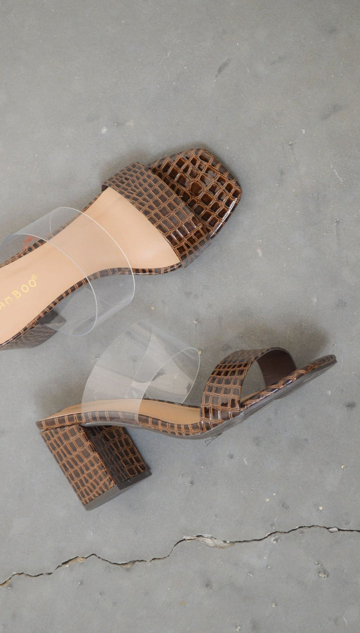 Brown snakeskin-patterned heeled sandals.