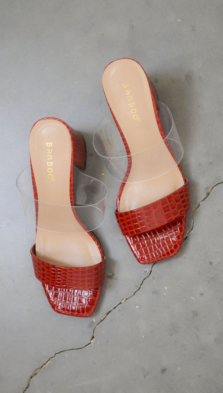 Red faux-crocodile heeled sandals.