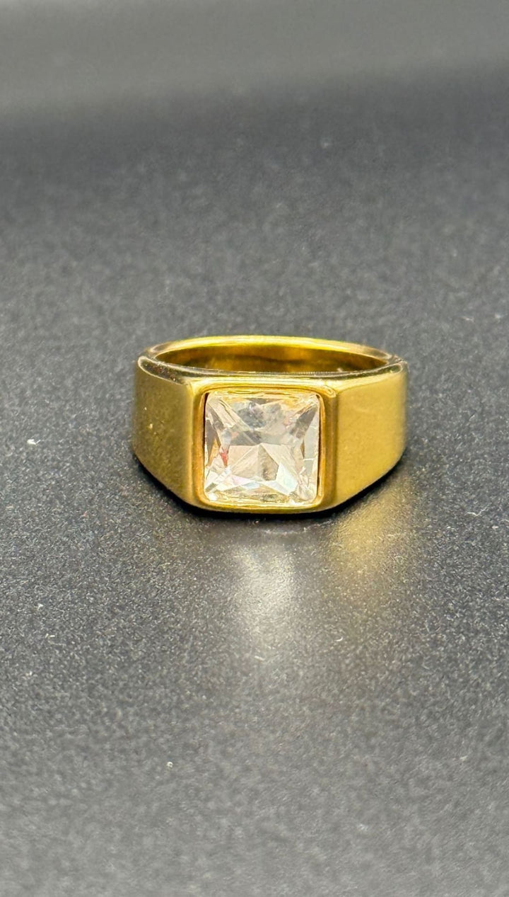 Gold ring with square gemstone.