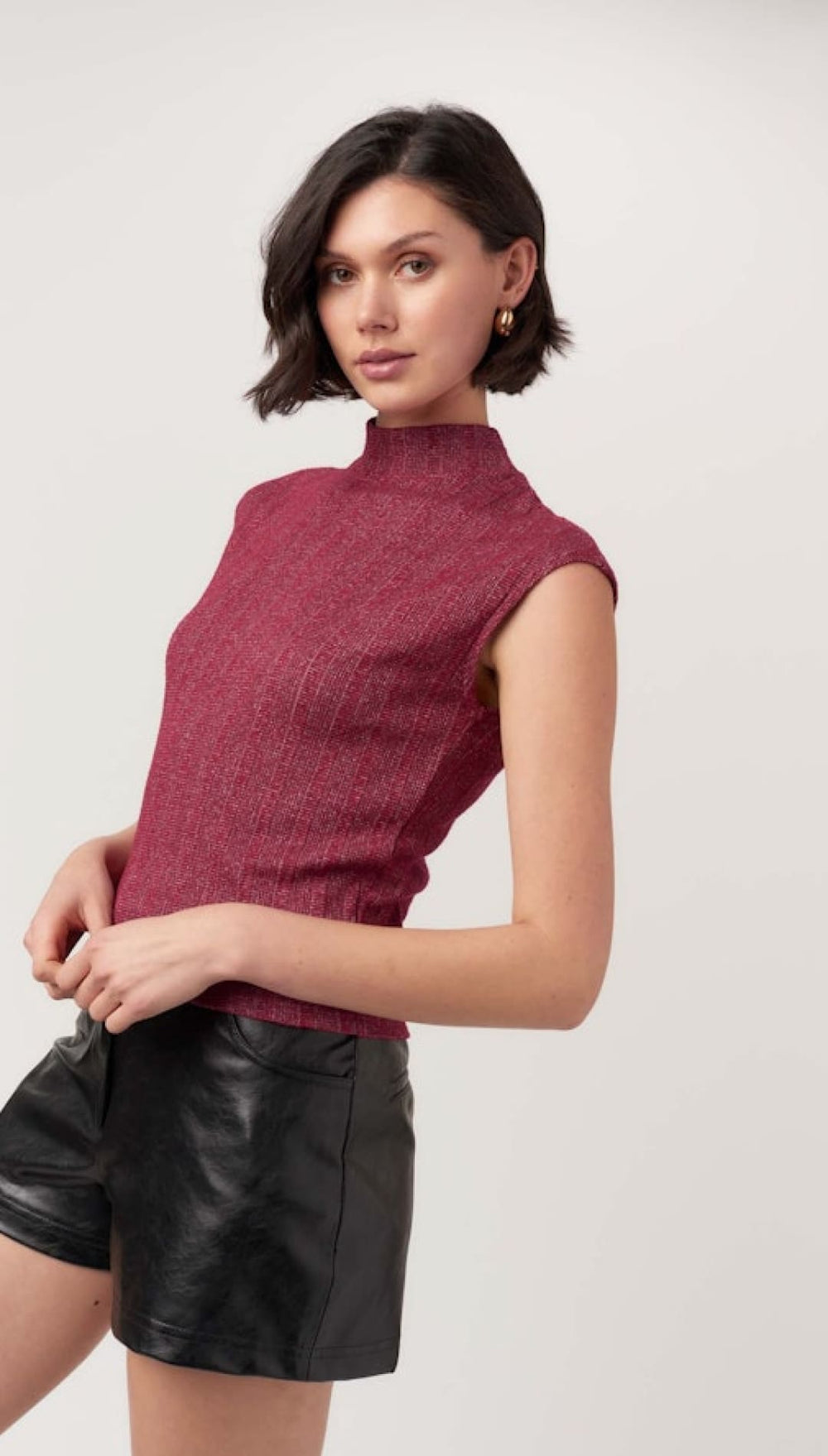 Burgundy mock-neck cap-sleeve knit top.