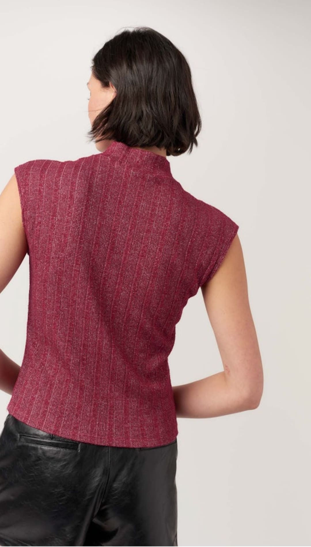 Women’s short-sleeved mock neck top in a shimmery dark pink knit.