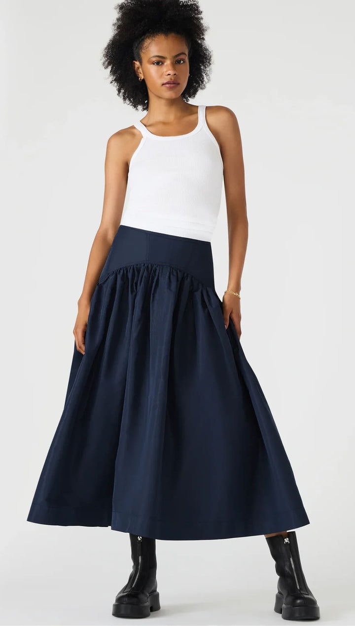A dark blue, wide-pleated midi skirt with a gathered waist.