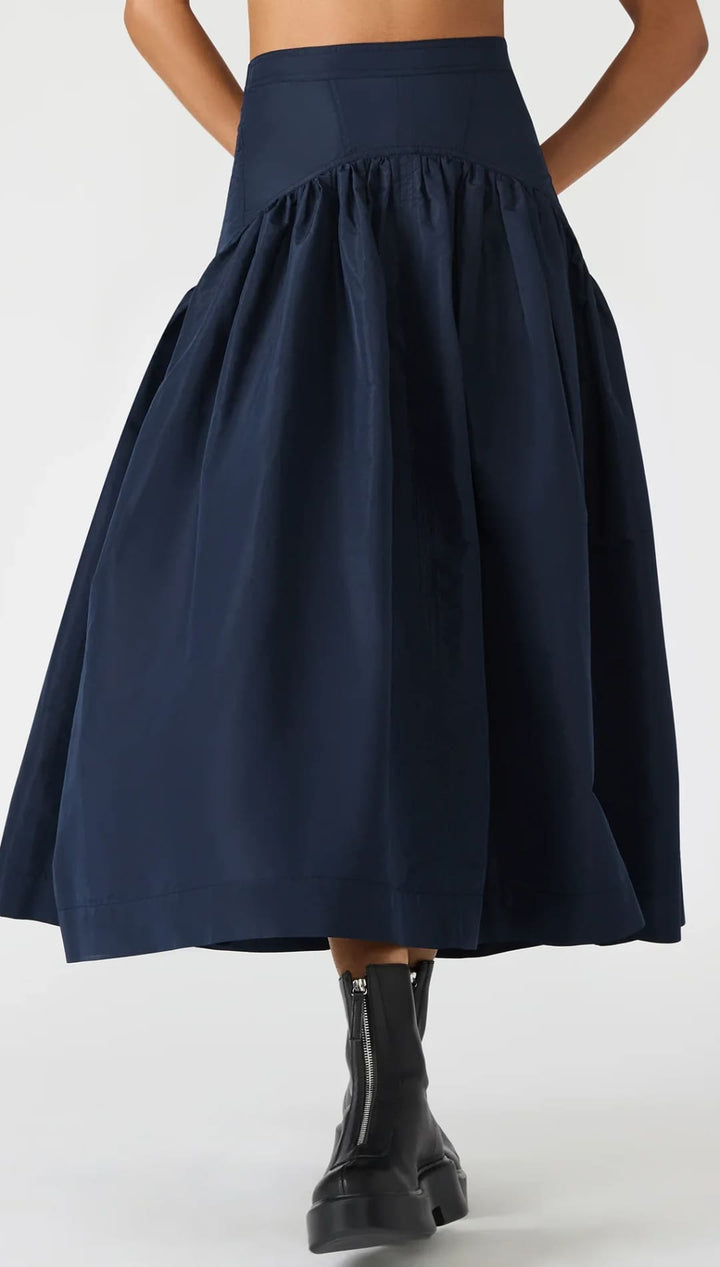 Navy blue high-waisted midi skirt with a gathered waist and full silhouette.