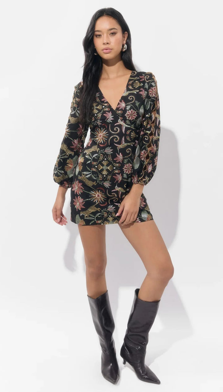Black and gold floral mini dress with puff sleeves, leather boots.