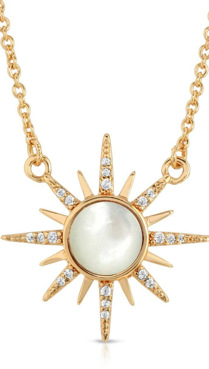 Gold sunburst pendant necklace.