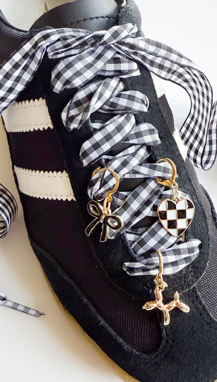 Black sneaker with gingham ribbon laces.