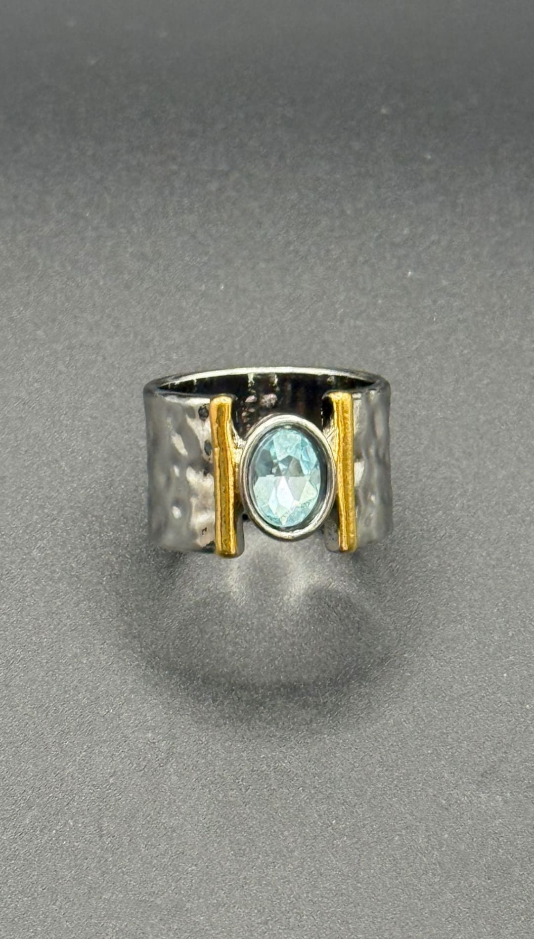 Silver ring with blue gemstone.