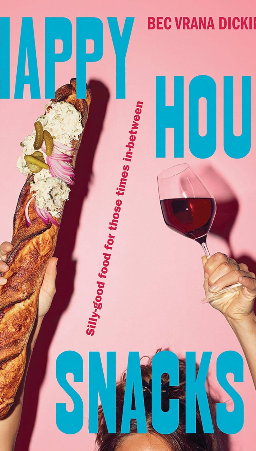 Pink background with a baguette and wine glass in hands.