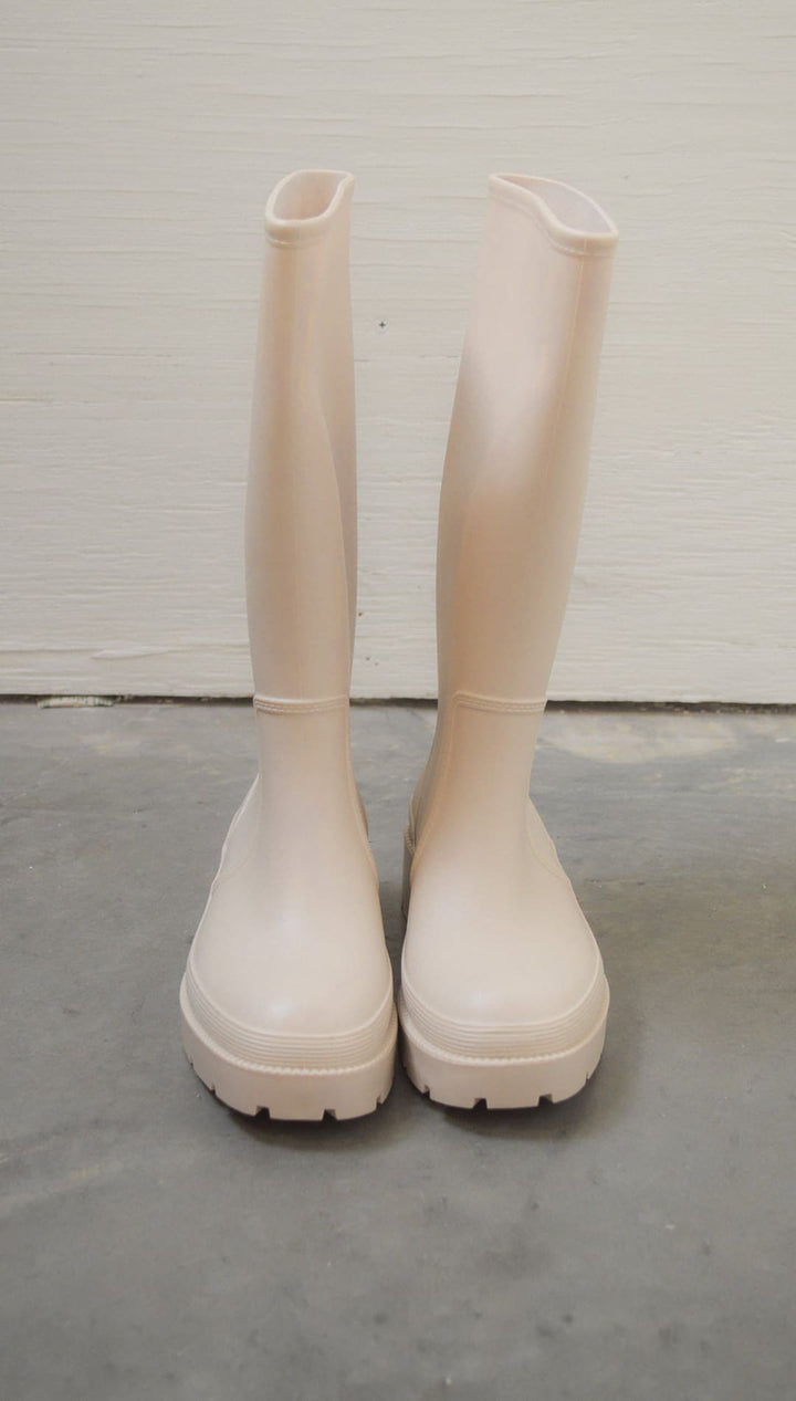 Pair of light pink rain boots.