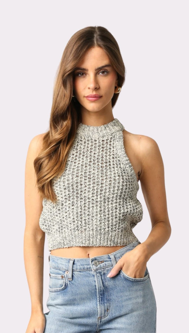 Woman wearing a gray knit halter top.