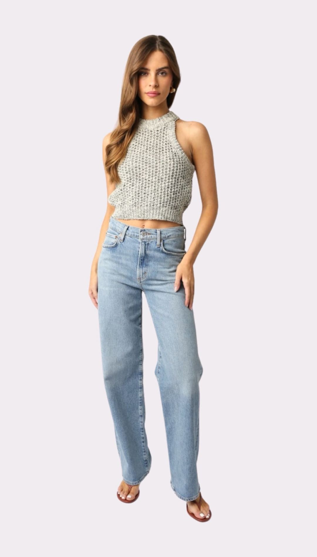 Woman wearing a knit halter top and wide-leg jeans.