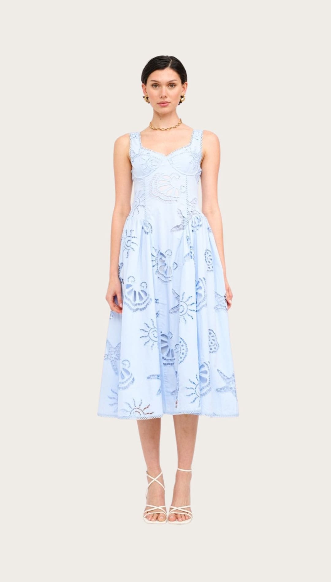 Light blue sundress with nautical motifs.