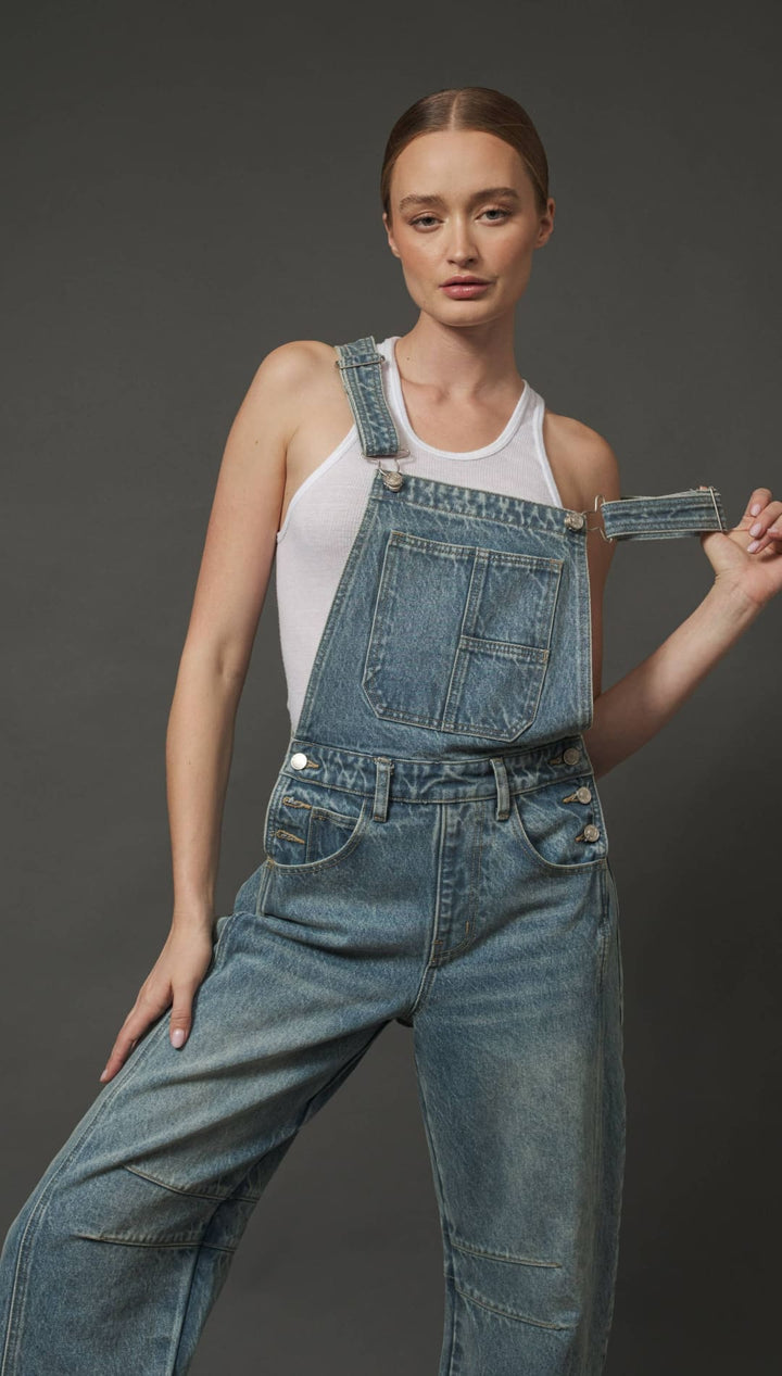 Denim overalls with patch pockets and adjustable straps.