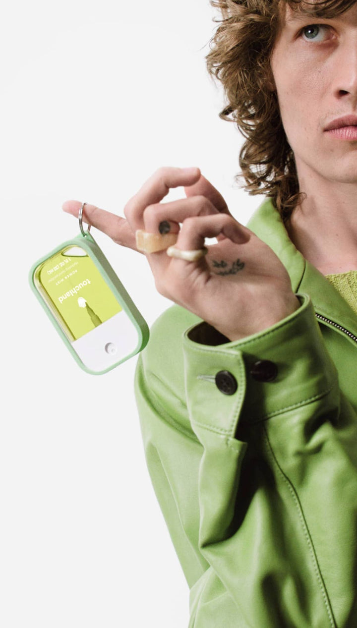 Green leather keychain with clear plastic cover and number 1 charm.