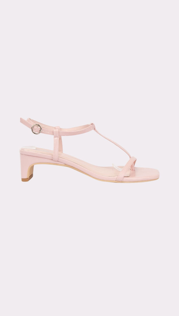 Pink T-strap heeled sandal.