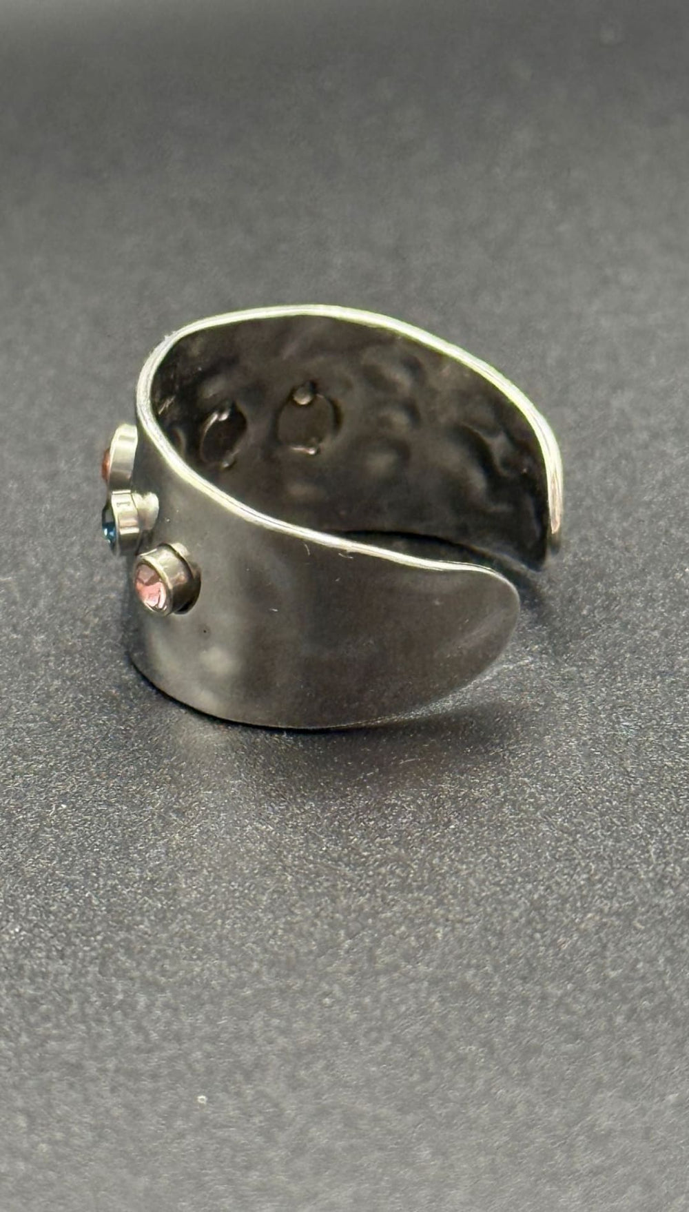 Silver ring with colorful gems.