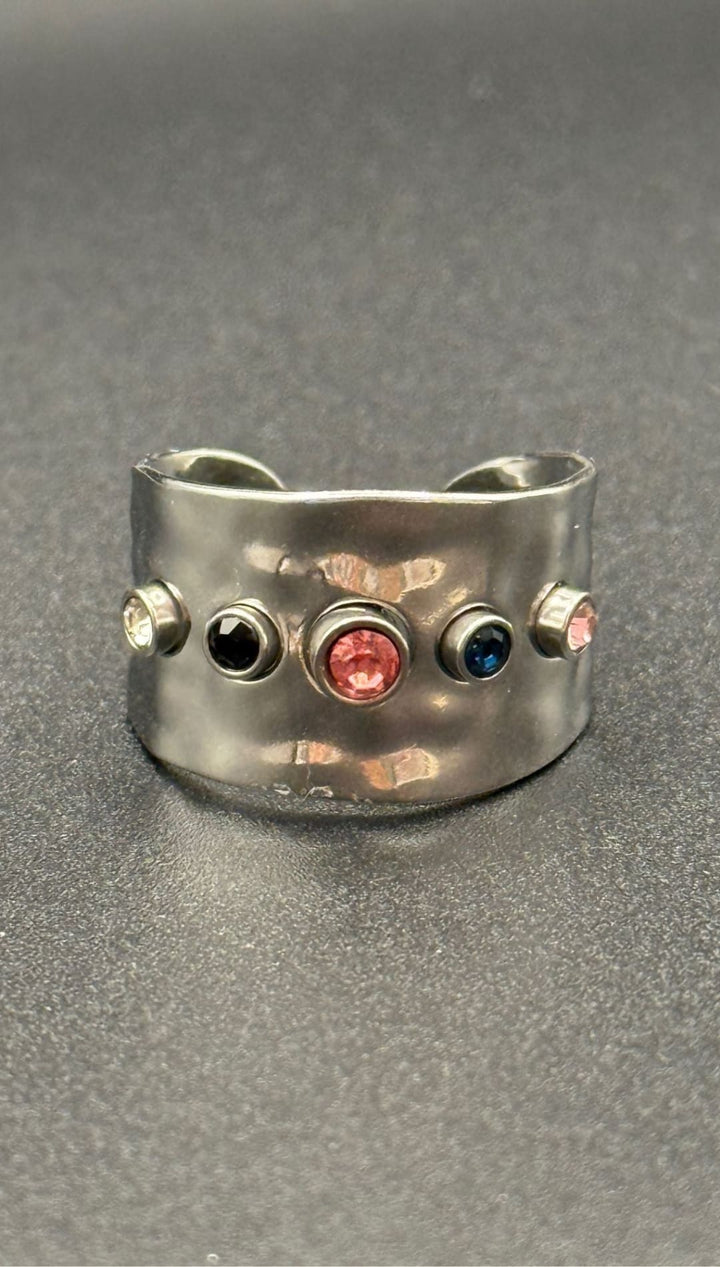 Silver ring with colorful gemstones.