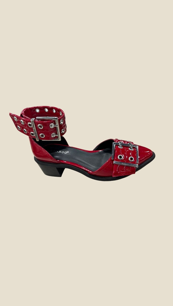 Red patent leather Mary Jane-style flats with multiple silver buckles and eyelets.