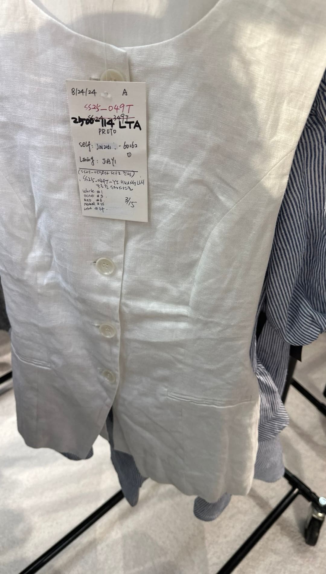 White linen button-down vest.