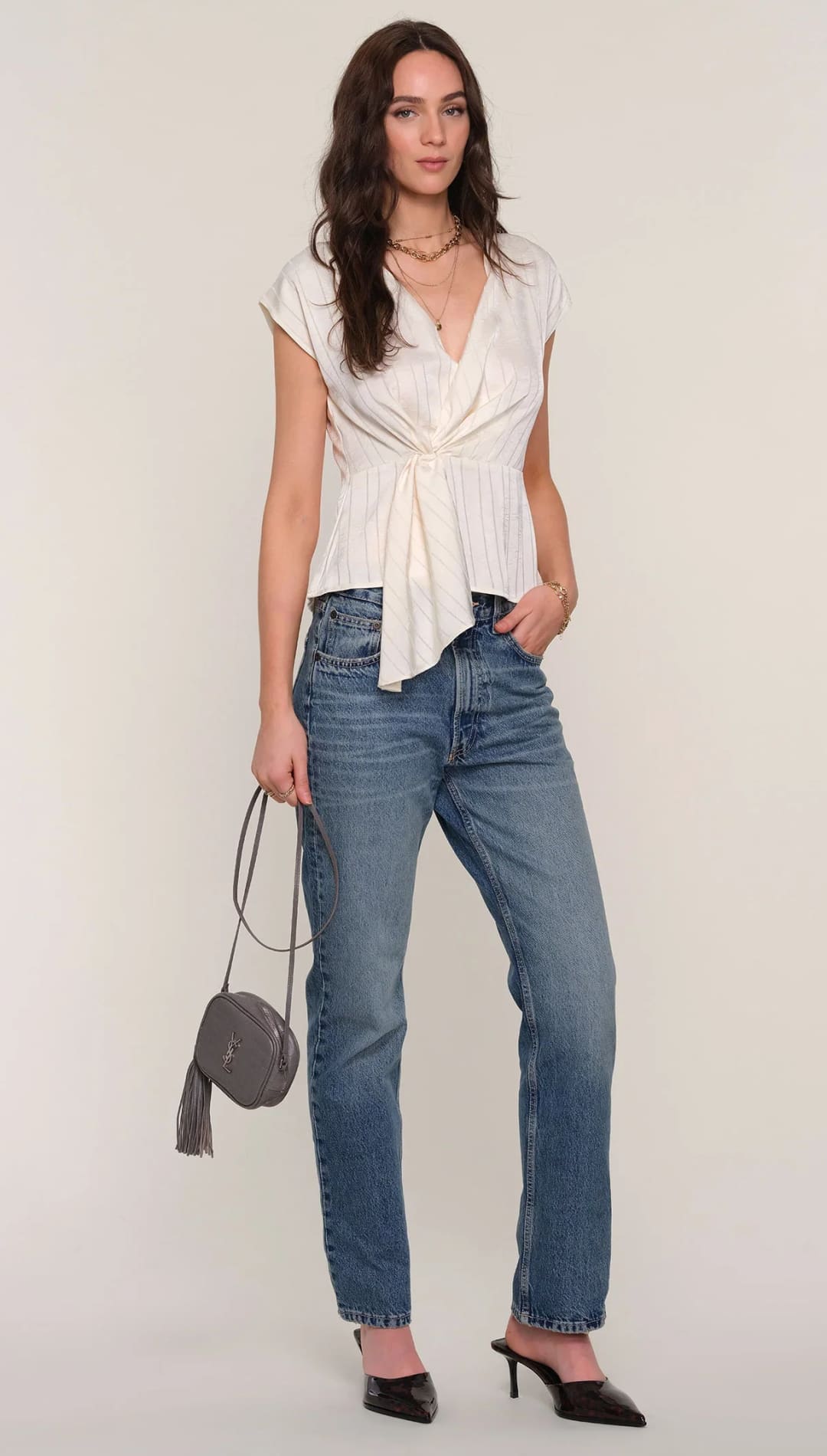 Women’s cream-colored short-sleeved top with a v-neck and a knotted front design.