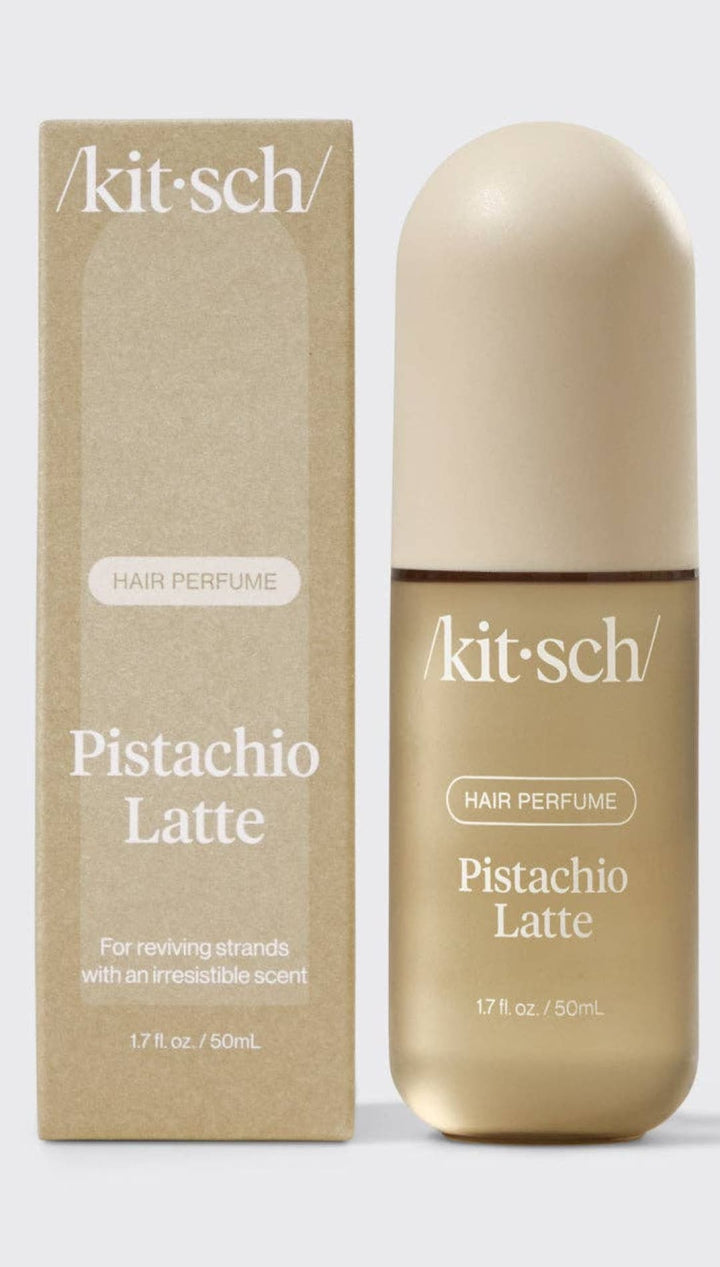 Pistachio latte hair perfume by kitsch in a sleek, gold-colored bottle with white label.