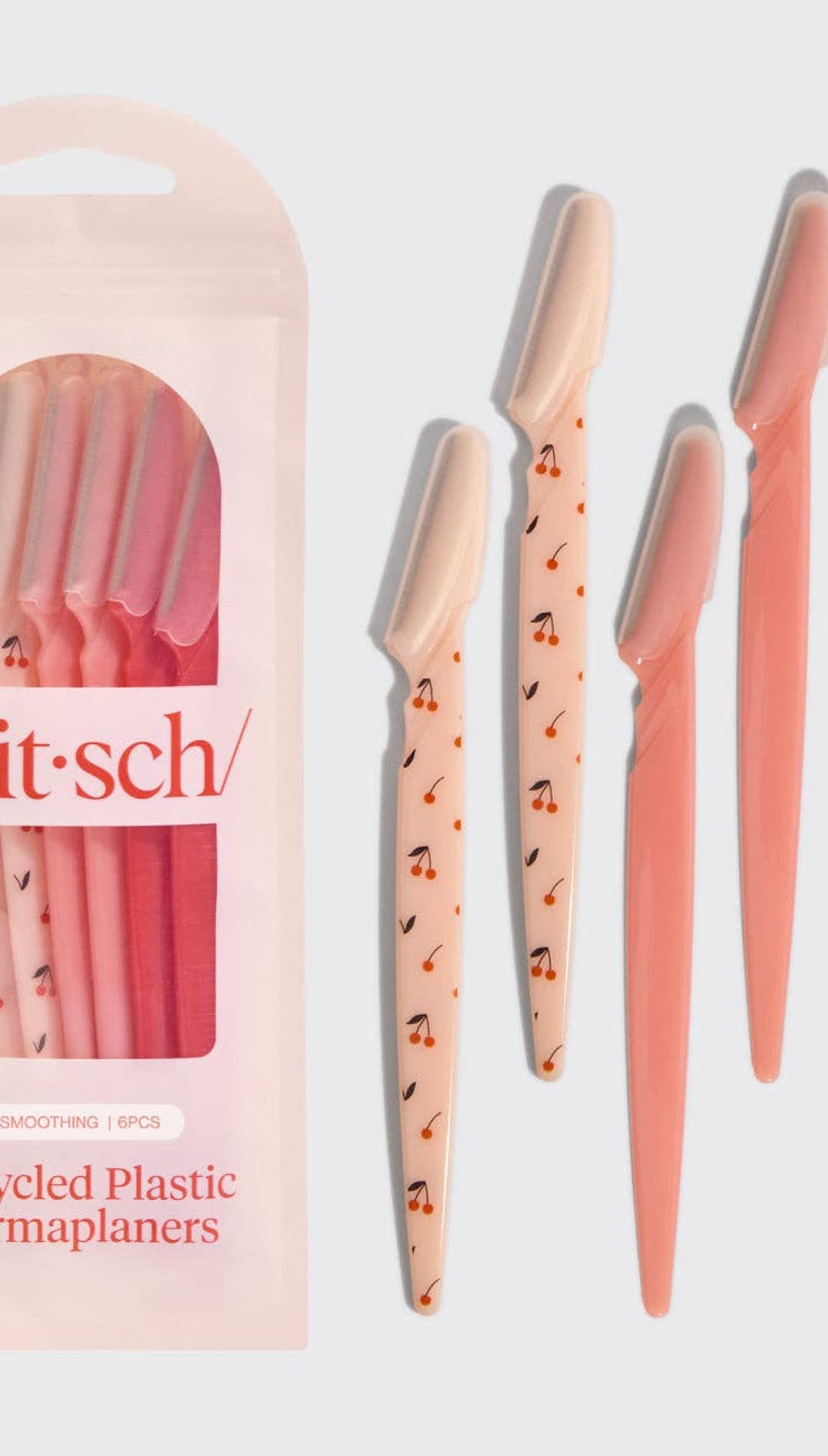 Kit-sch recycled plastic dermaplaners in peach and coral with musical notes design.