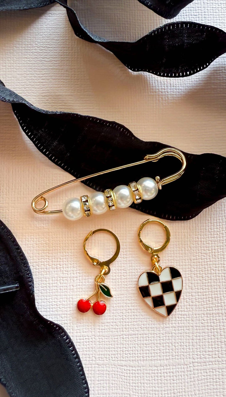 Assorted jewelry with black ribbon.