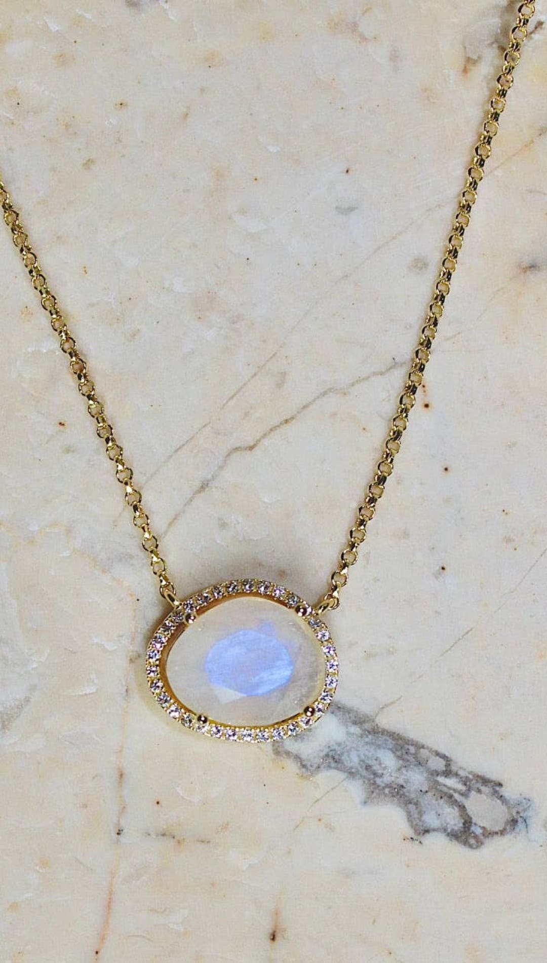 Gold necklace with moonstone pendant.