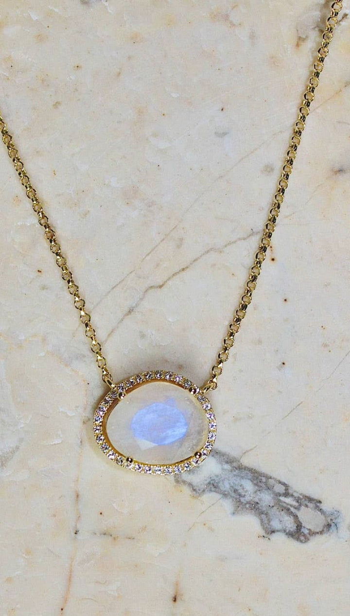 Gold necklace with moonstone pendant.