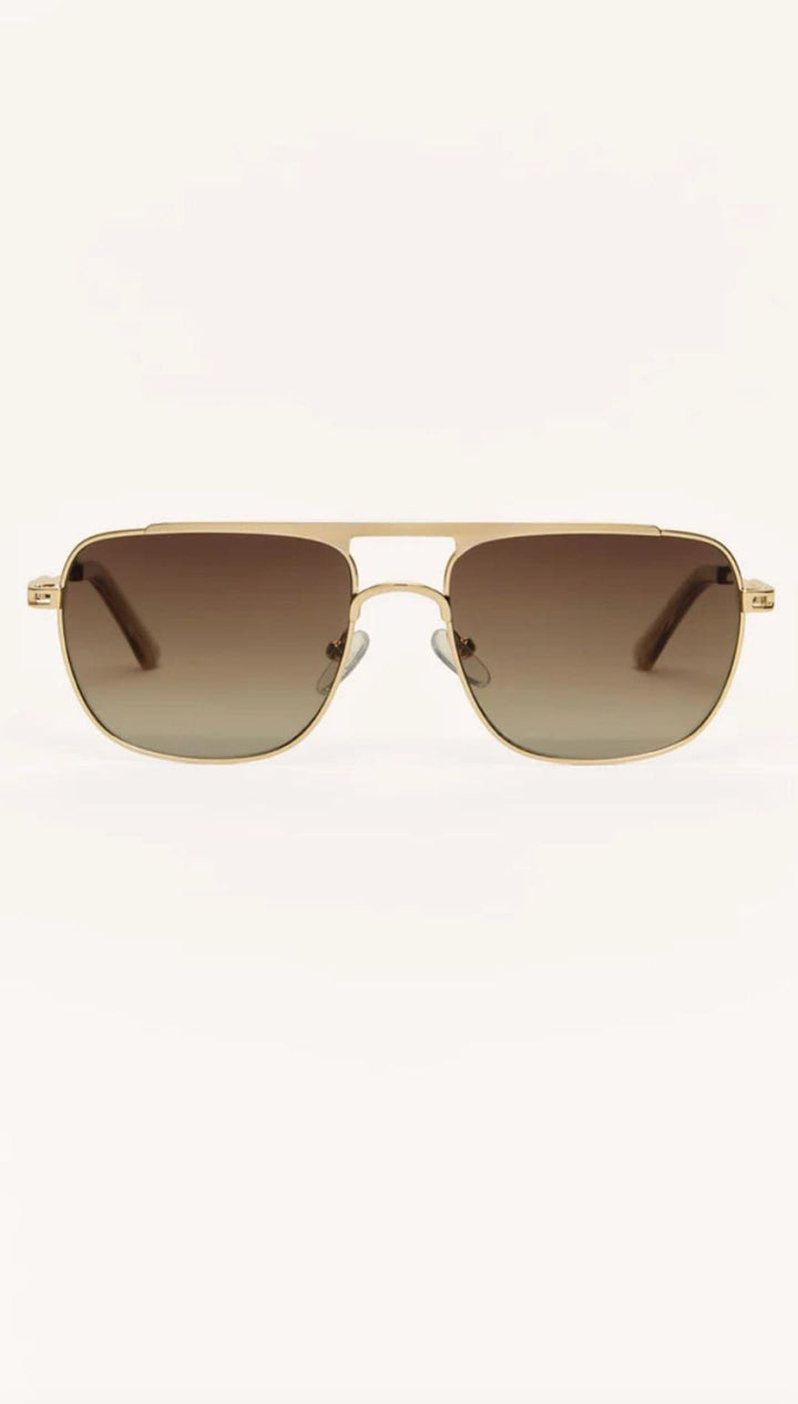 Gold-framed aviator sunglasses with brown gradient lenses.
