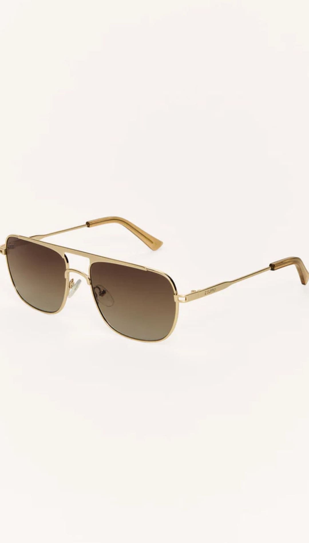 Gold-framed aviator sunglasses with gradient lenses.