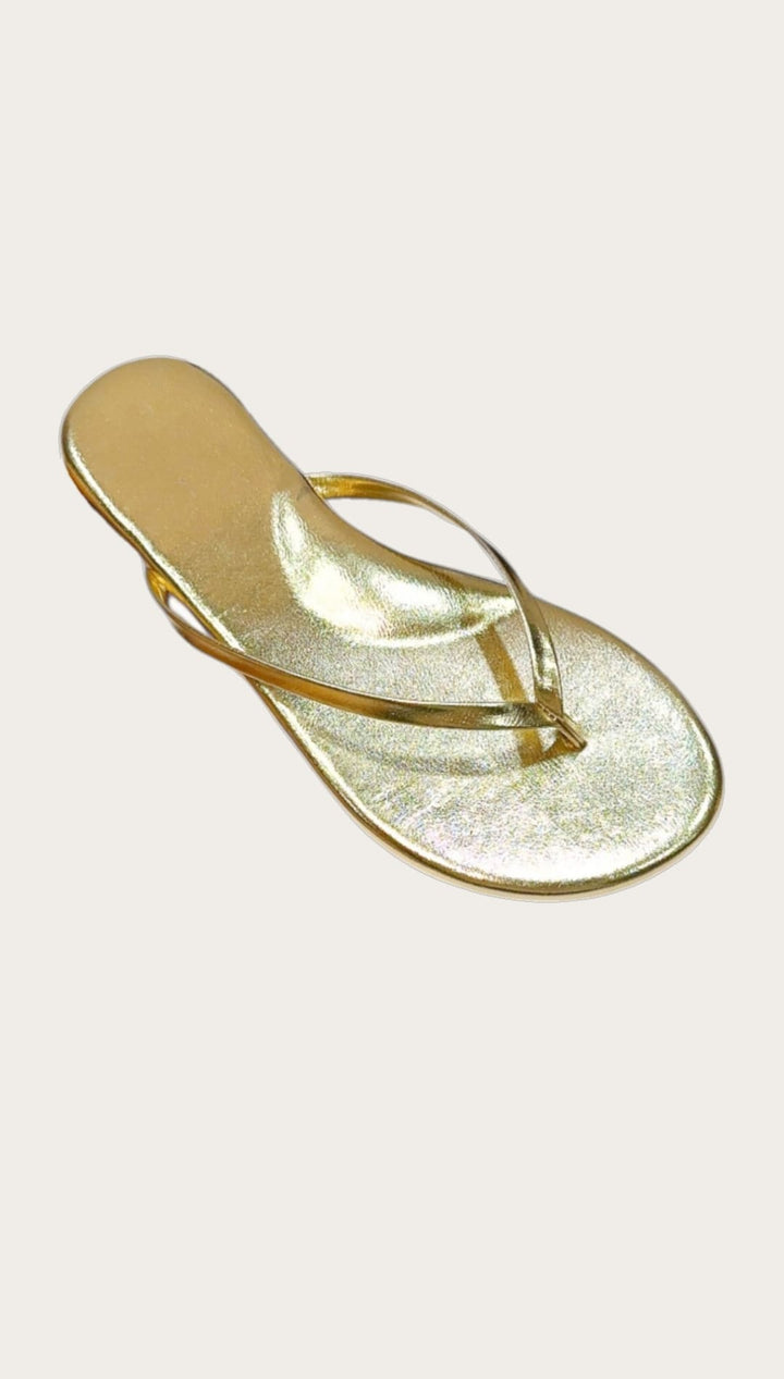 Gold-colored flip-flop sandal.