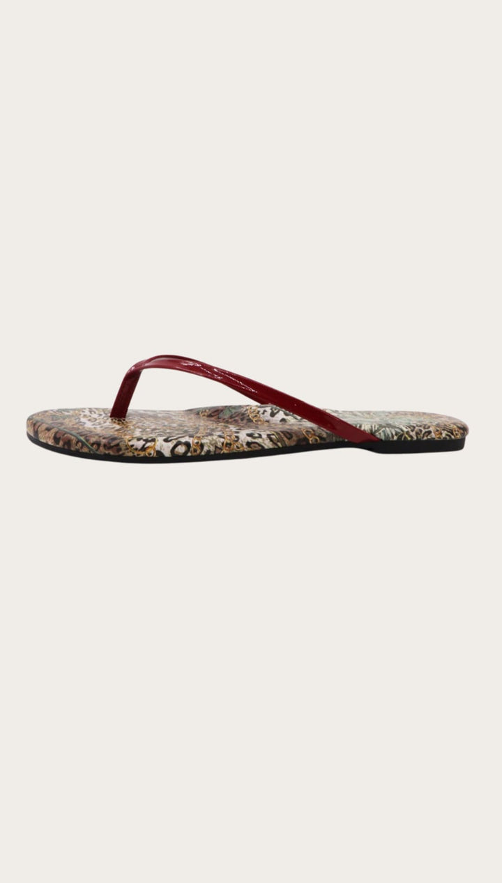 Leopard-print flip-flop with red strap.