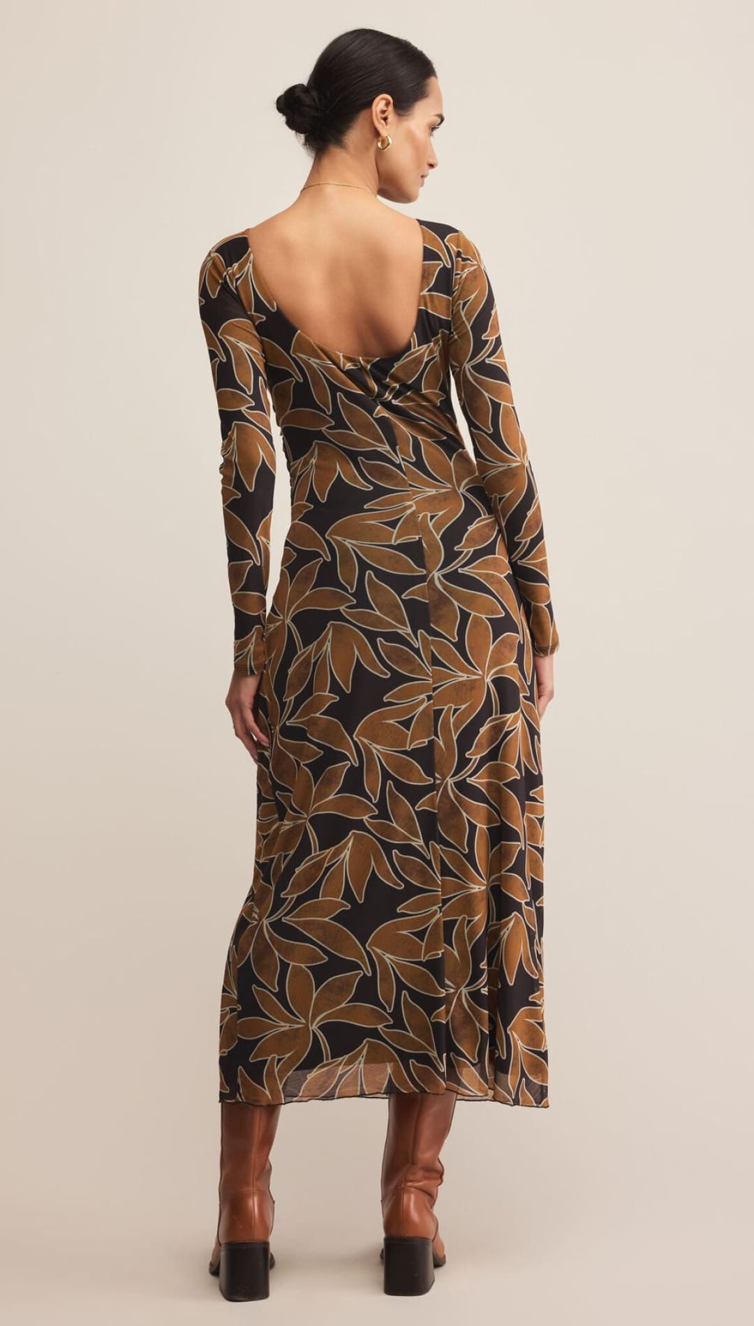Brown and green leaf print wrap dress with long sleeves.