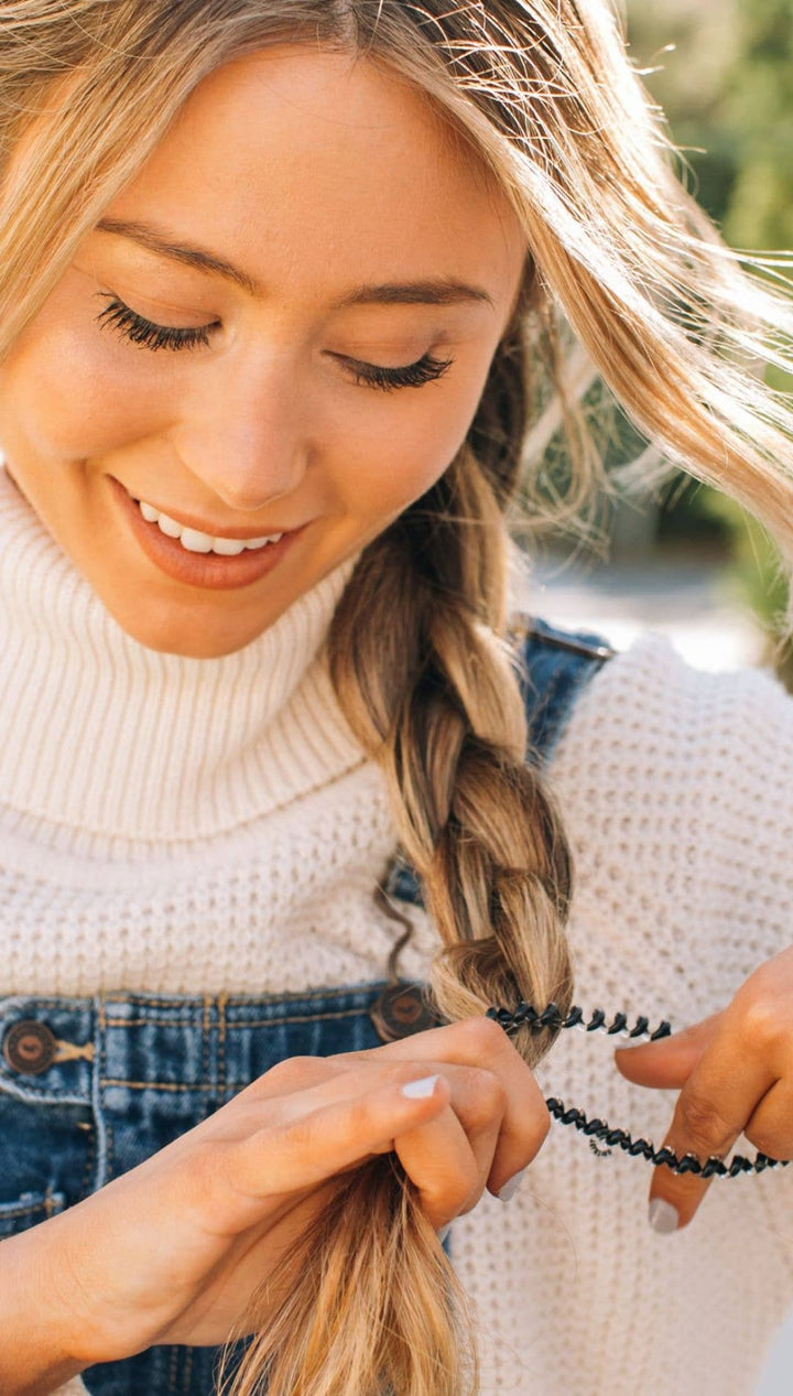 Black beaded hair tie with a sleek, modern design.